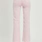 Pink RISEN high rise full size tummy control straight jeans with raw hem detail from the back, paired with clear heels.