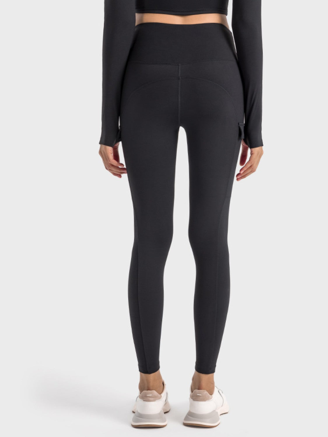 Back view of Millennia wide waistband sports leggings showcasing a sleek design and hidden pockets.