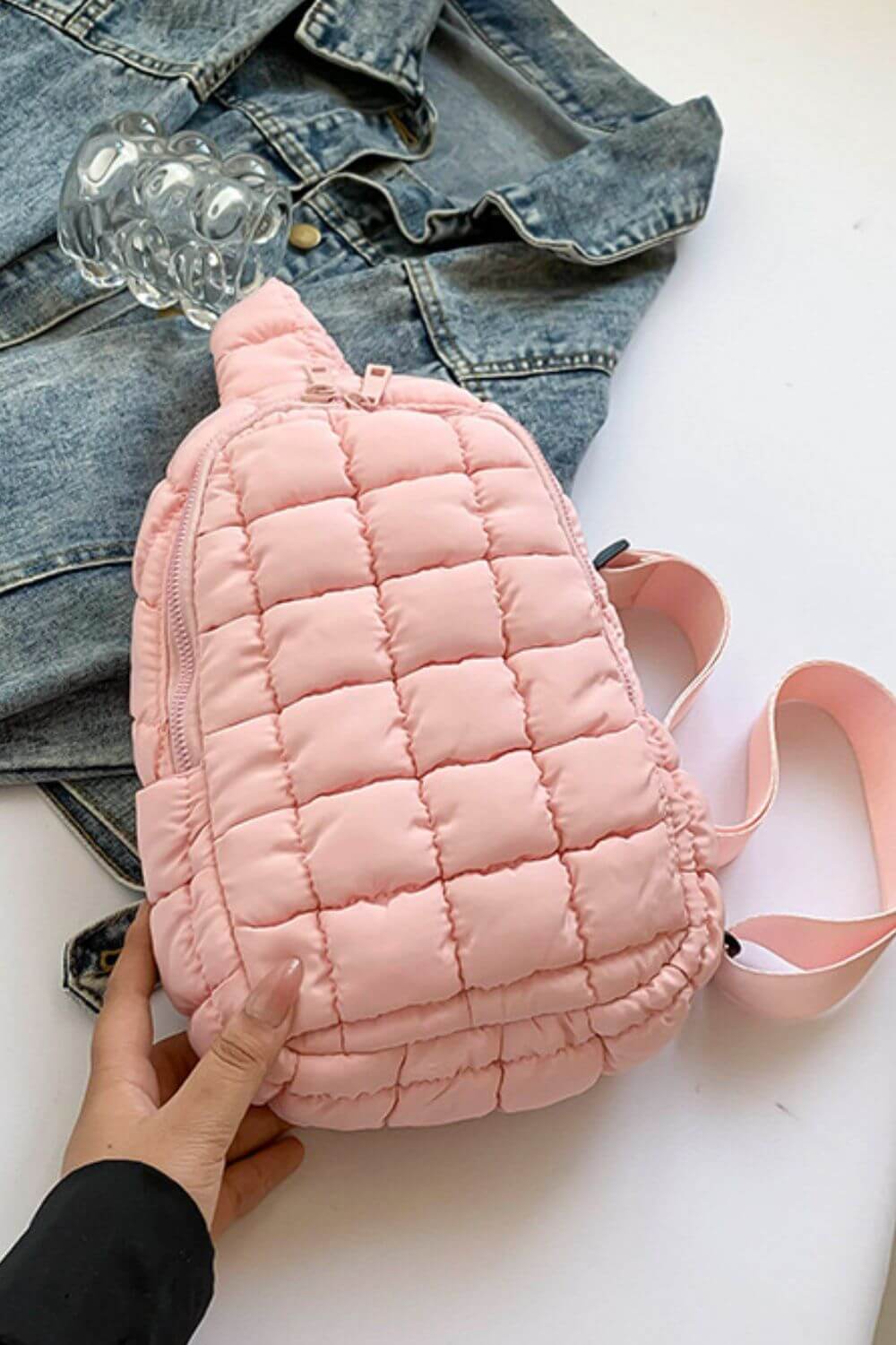 Pink Bella Road Quilted Nylon Crossbody Bag styled with denim jacket, perfect for trendy adventures.