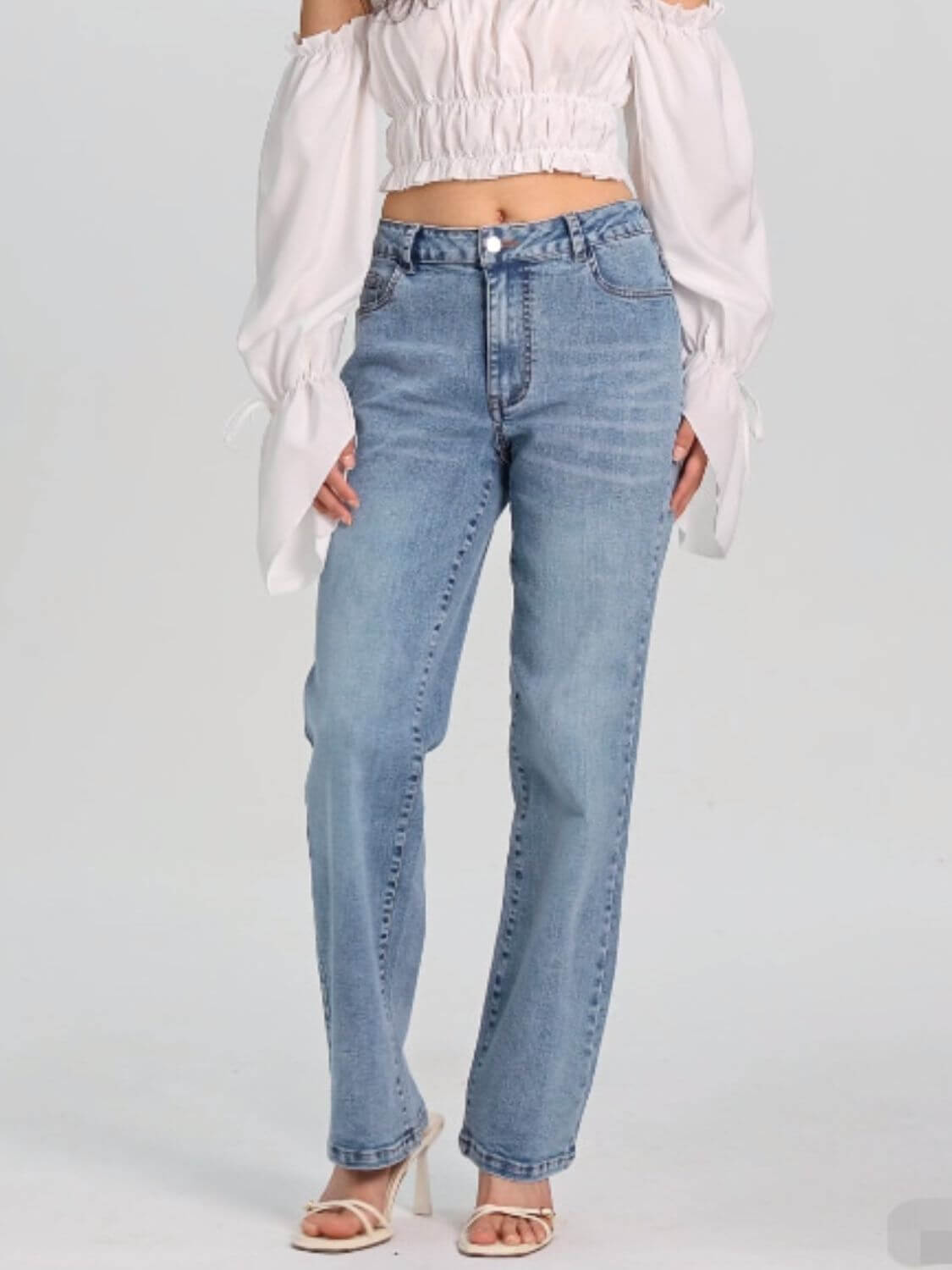 Woman wearing Bella Road Straight Jeans with Pockets, stylish and comfortable for versatile outfits, slightly stretchy denim.