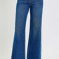 High rise wide leg jeans with tummy control, pockets, and frayed hem, styled with sandals for a chic look.