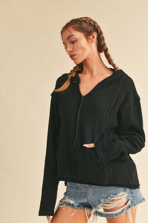 Aemi + Co frayed hem exposed seam long sleeve hoodie styled with distressed shorts, perfect for a casual look.