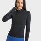 Millennia Half Zip Thumbhole Sleeve Sports Top in black, perfect for yoga and workouts, featuring a stylish design and comfortable fit.