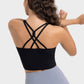 Model showcasing the stylish crisscross back of the Millennia Active Tank in black, perfect for workouts and comfort.