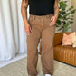 High Rise Garment Dye Wide Leg Jeans in rich brown color with a relaxed, flattering fit modeled with a black top and white sneakers.