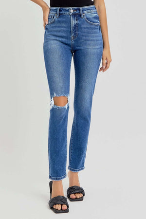 RISEN full-size high-rise ankle skinny jeans with knee distressing, washed blue denim, slightly stretchy, and pocketed, worn with black sandals.