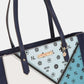 Nicole Lee USA color block handbag with floral and logo pattern, close-up of straps and design.