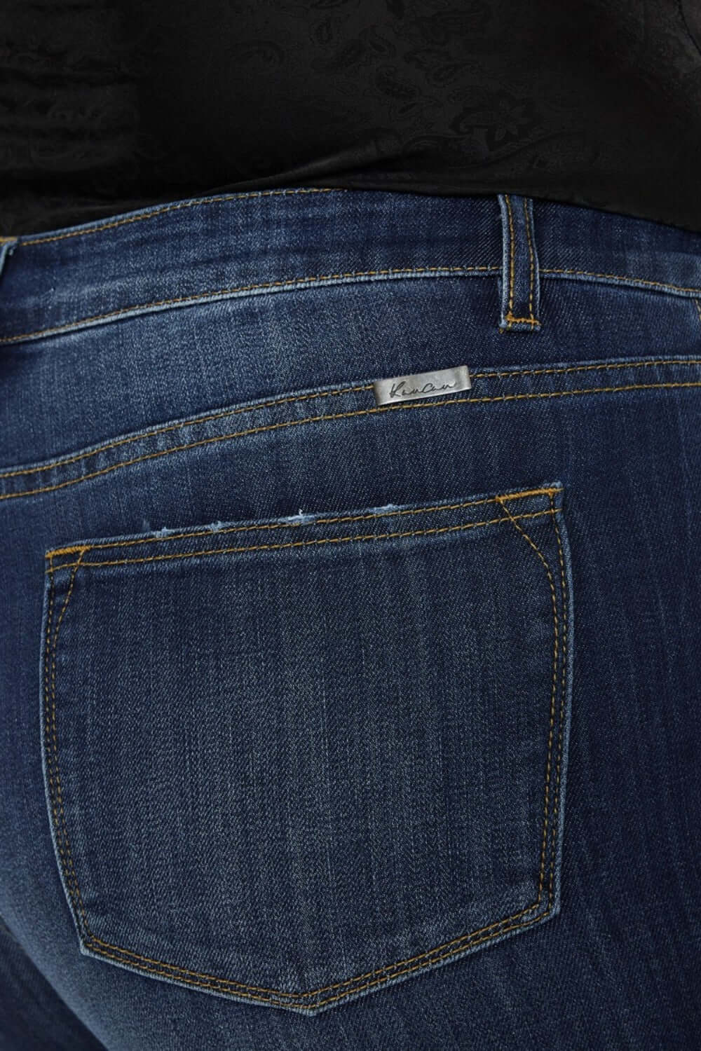 Close-up of Kancan mid-rise slim flare jeans in dark stone wash, showcasing stretch denim and classic stitching.