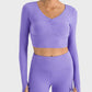 Millennia Ruched Cropped Long Sleeve Sports Top in purple, featuring stylish ruched design and a trendy cropped fit.