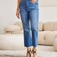 Woman wearing Mini Mia Full Size Tummy Control High Waist Jeans | Petite by RFM Jeans in a living room setting