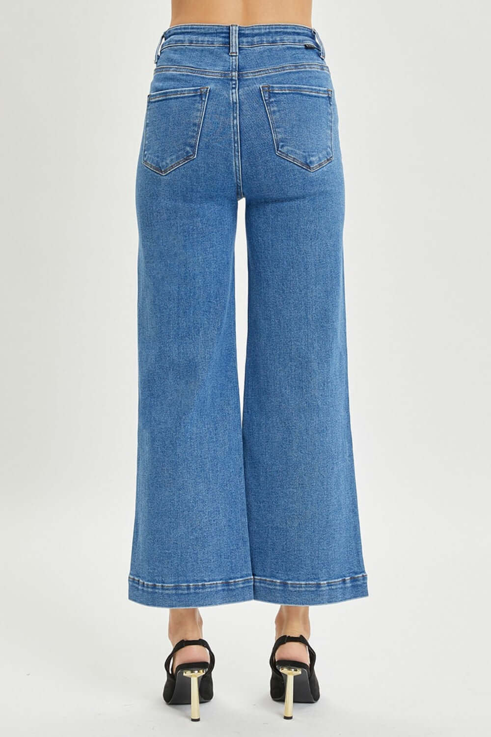 Back view of high-rise wide-leg Risen Jeans in petite size, featuring a flattering fit and retro flair for stylish outfits.