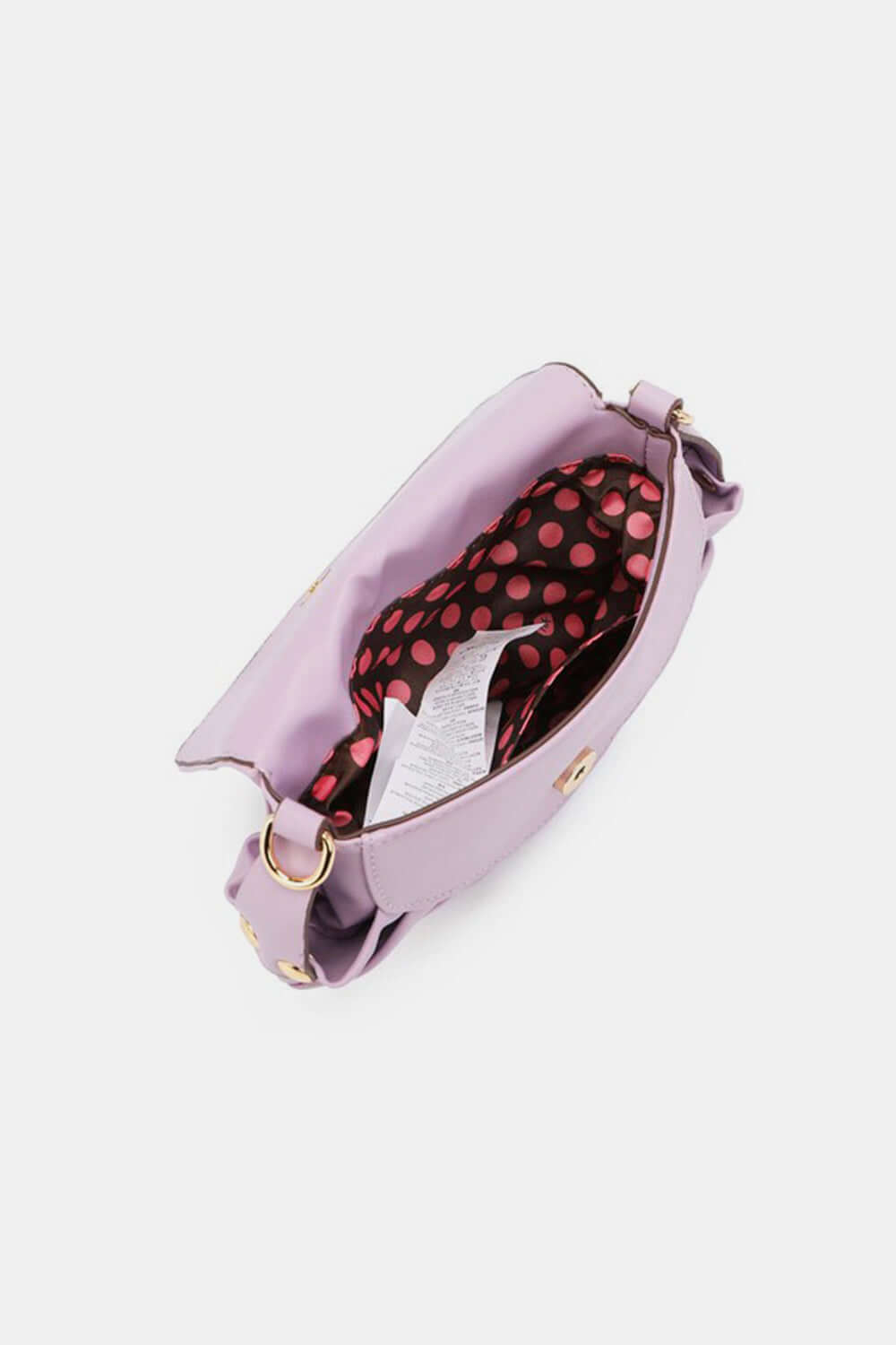 Nicole Lee USA Graphic Crossbody Bag interior view showing storage capacity with polka dot lining and adjustable strap.