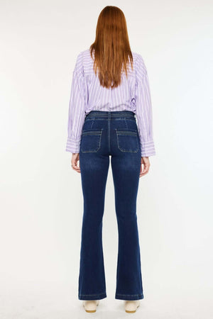 Woman wearing Kancan high-rise double waistband flare jeans in dark wash with welt pockets, stylish and versatile denim fashion.