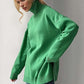 Cozy green turtleneck sweater with side slits and dropped shoulders, perfect for a stylish and comfortable look.