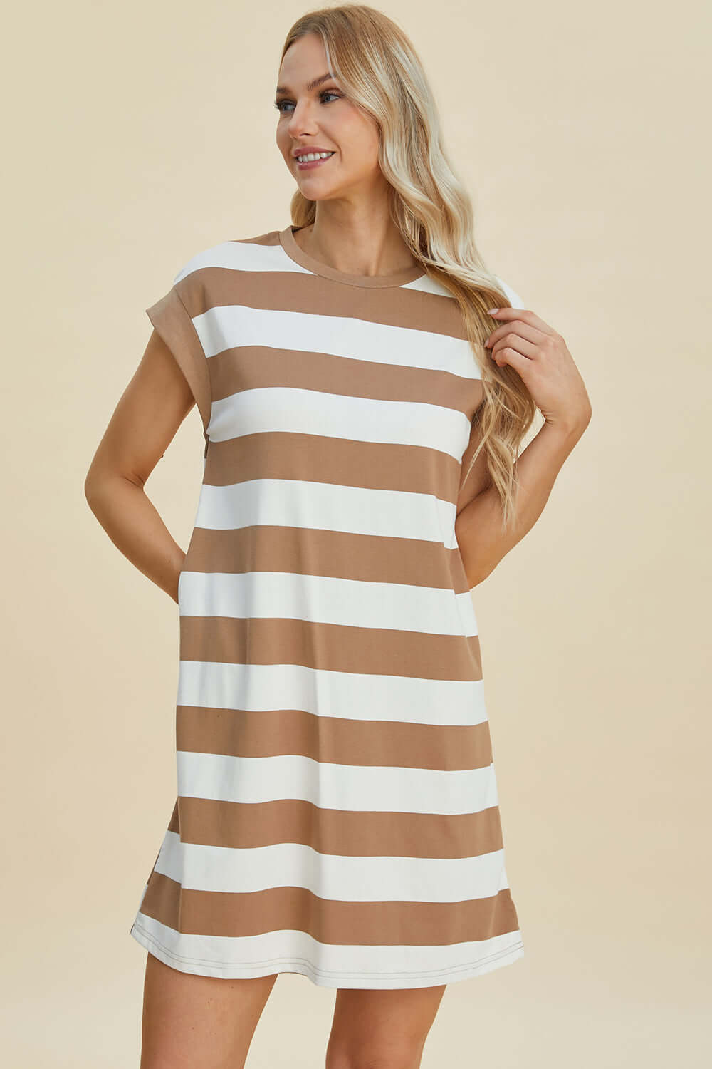 Woman wearing a Basic Bae full-size striped round neck cap sleeve mini dress in beige and white. Stylish and comfortable for any occasion.