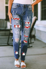 Woman wearing Bella Road Santa Graphic Distressed Jeans with Pockets, front view showing distressed details and Santa print.