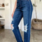 Woman wearing High Waist Rigid Magic Heavy Destroy Straight Judy Blue Jeans with heavy distressing and a stylish straight-leg design.