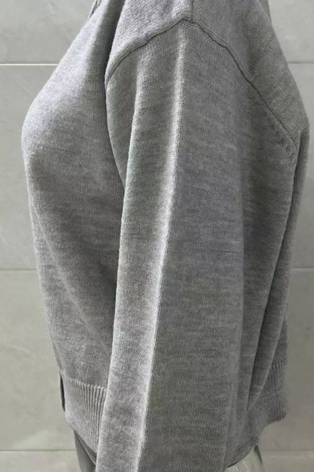 Side view of a cozy gray Bella Road Button Down Long Sleeve Cardigan, showcasing its relaxed fit and soft texture.