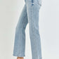 Woman wearing RISEN Full Size High Rise Ankle Flare Jeans in light denim, showcasing the high-waisted fit and trendy flared hem.