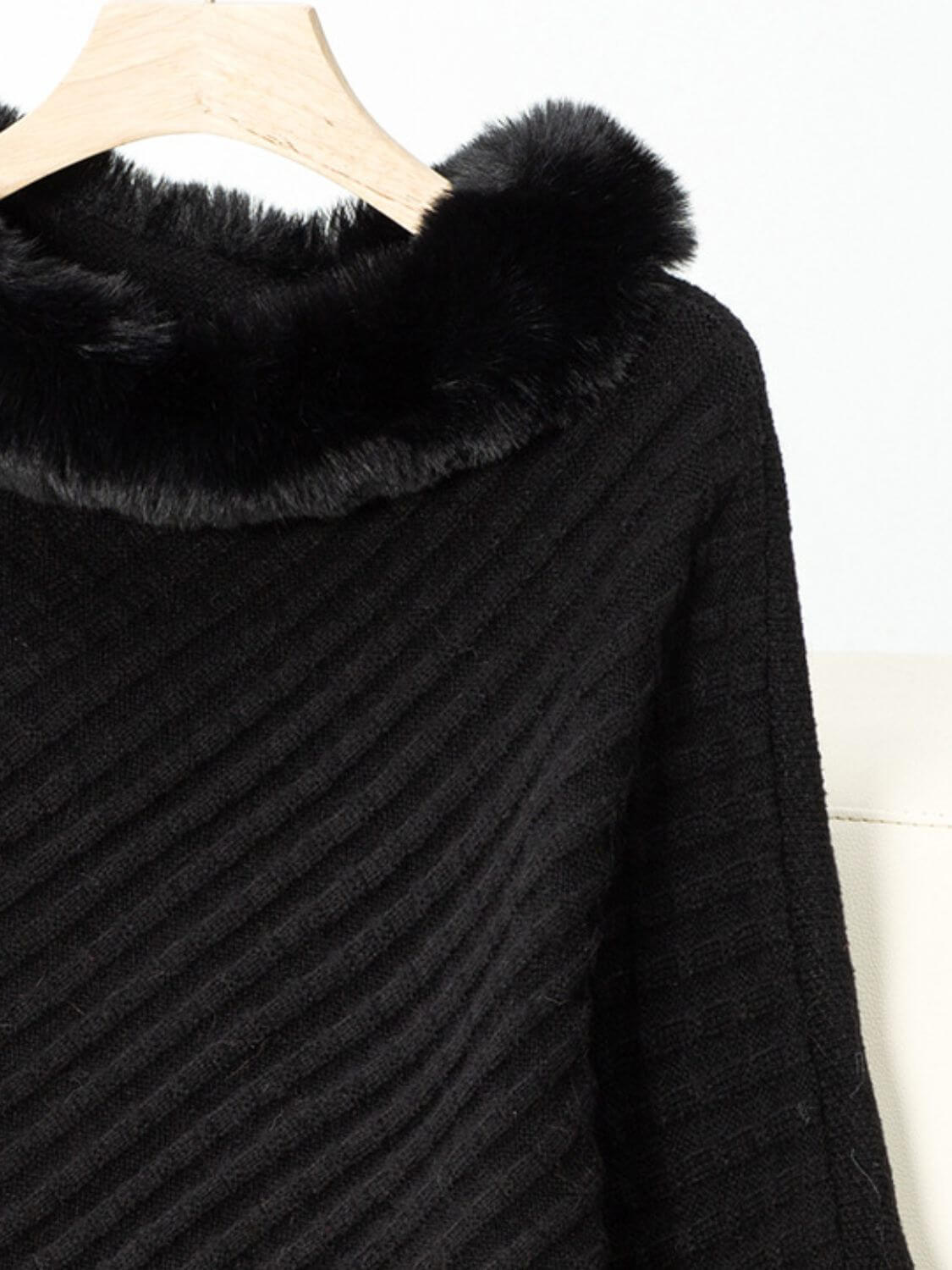 Close-up of Bella Road Fuzzy Trim Poncho showcasing soft black fabric and cozy fur collar detail. Perfect for stylish warmth!