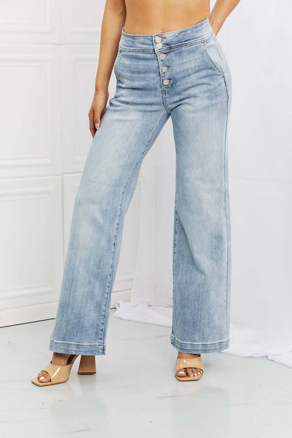 Woman wearing Luisa Wide Flare Jeans with button fly closure and functional pockets by Risen Jeans