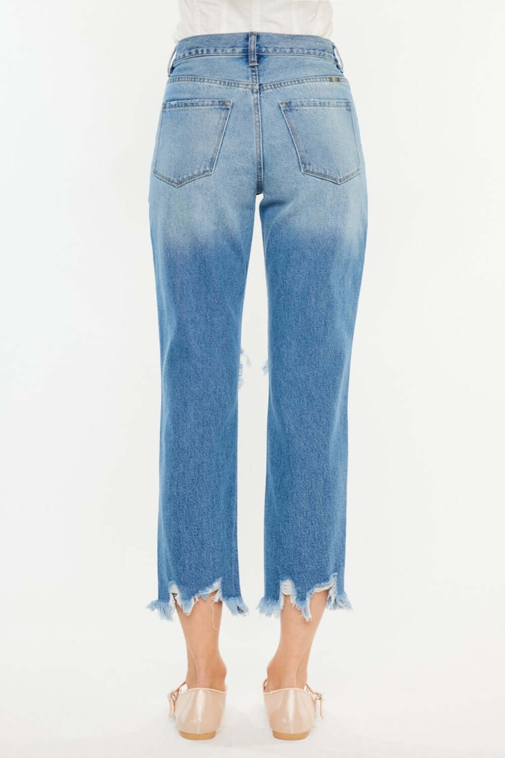 Distressed frayed hem cropped jeans with a trendy worn-in vibe, perfect for a casual chic look.