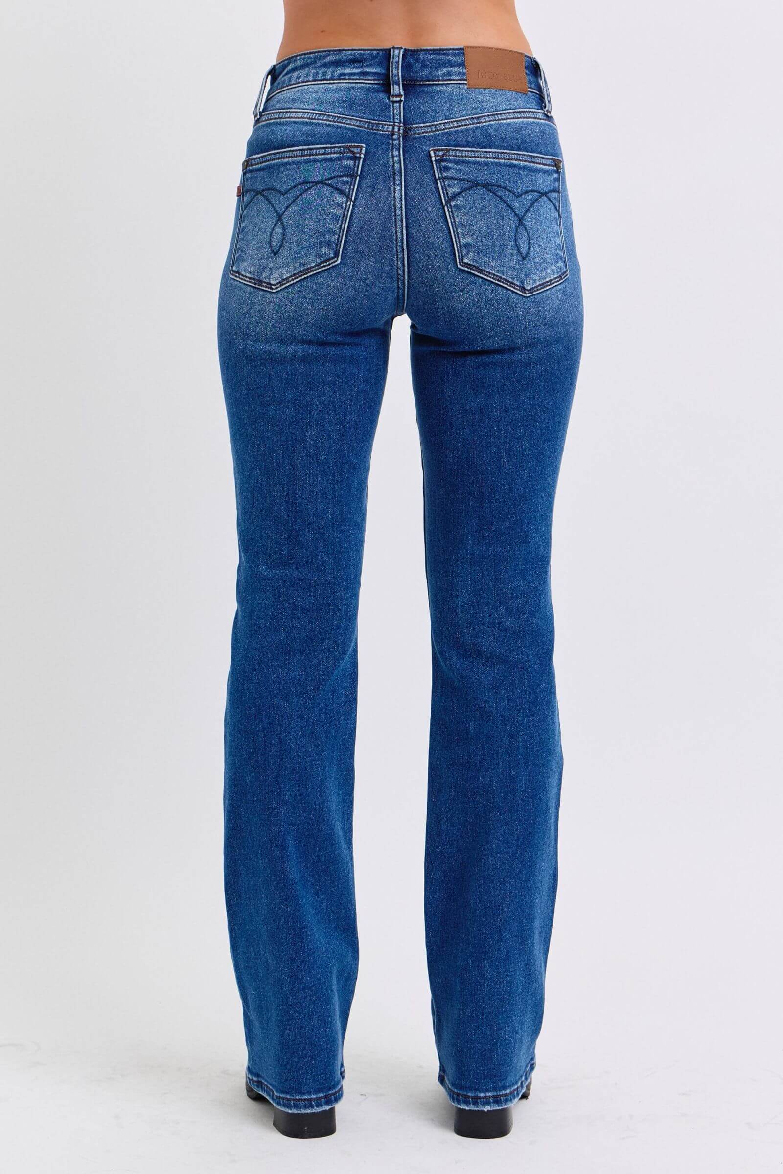 Back view of Judy Blue mid-rise bootcut jeans with thermal lining, showcasing the flattering fit and classic style.