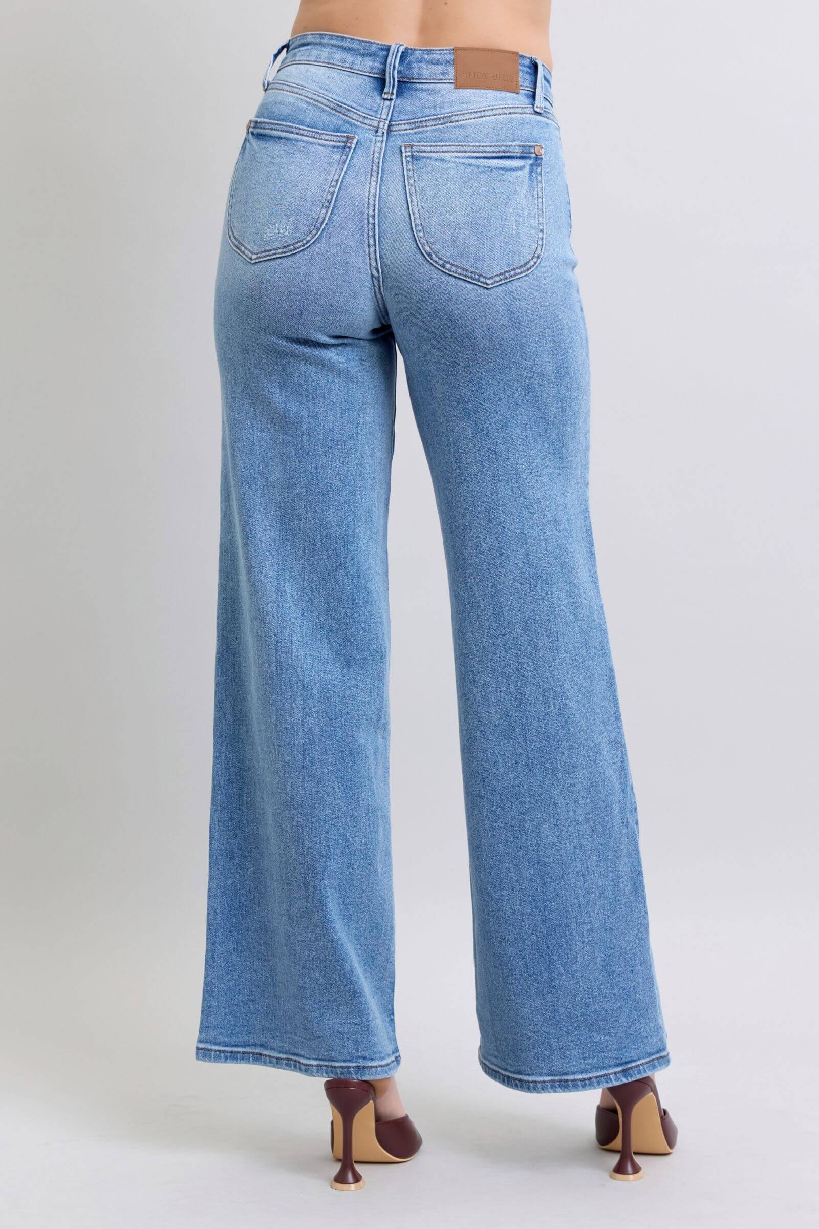 Back view of Judy Blue wide leg jeans in light blue, showcasing pockets and a relaxed vintage-inspired silhouette.