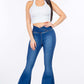 Woman wearing American Bazi high waist pull-on flare jeans with a white crop top, showcasing the slim and modern fit of the stretchy denim.