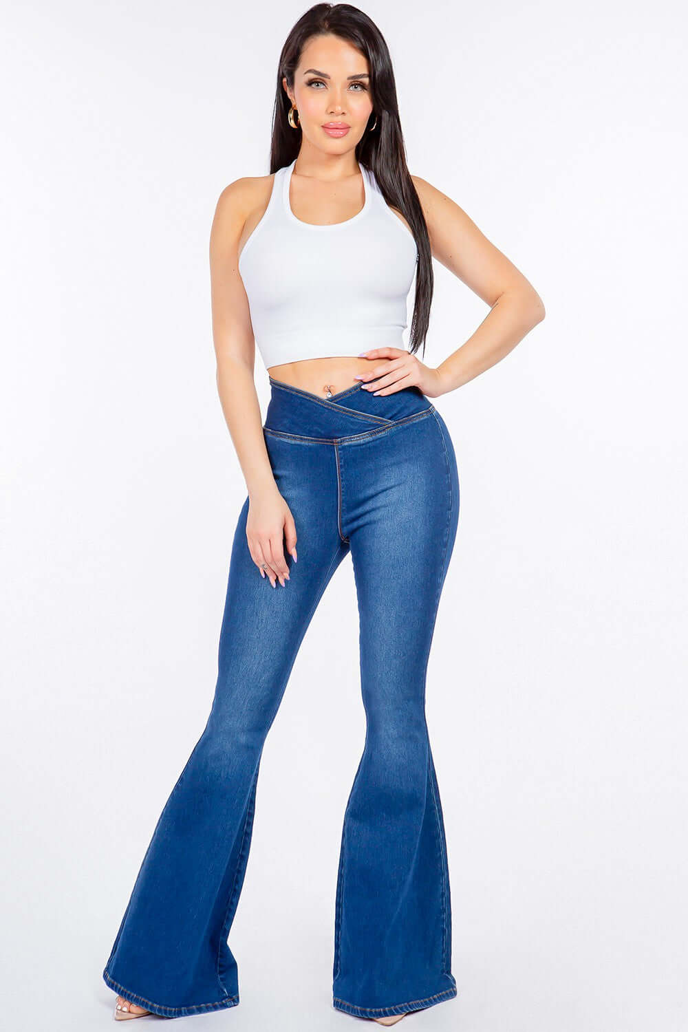 Woman wearing American Bazi high waist pull-on flare jeans with a white crop top, showcasing the slim and modern fit of the stretchy denim.