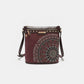 Nicole Lee USA crossbody bag with metallic stitching, embroidery, and inlaid rhinestones; front view displaying zip pockets.