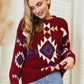 Woman wearing a red HEYSON Aztec sweater with geometric patterns, showcasing cozy and stylish charm.