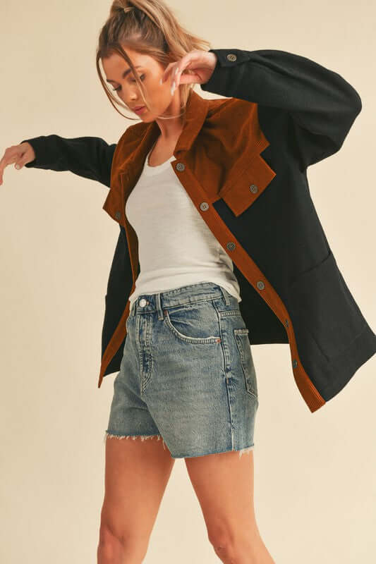 Stylish model wearing Aemi + Co Two-Tone Jacket, combining chic black and brown colors with comfy shorts. Perfect for any wardrobe!