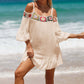 Crochet cold shoulder three-quarter sleeve cover-up with colorful flower detail, worn by the beach.