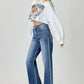 Model wearing RISEN high waist jeans with pockets, styled in a casual chic outfit with a cropped sweatshirt.