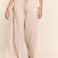 Smocked waist boho wide leg pants with pockets, offering relaxed style and comfort, perfect for casual or dressy events.