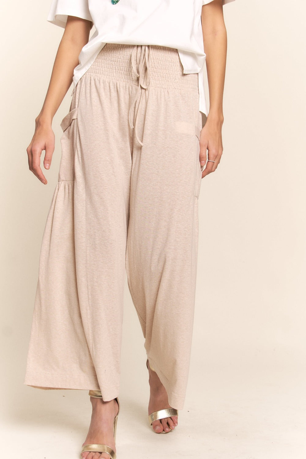 Smocked waist boho wide leg pants with pockets, offering relaxed style and comfort, perfect for casual or dressy events.