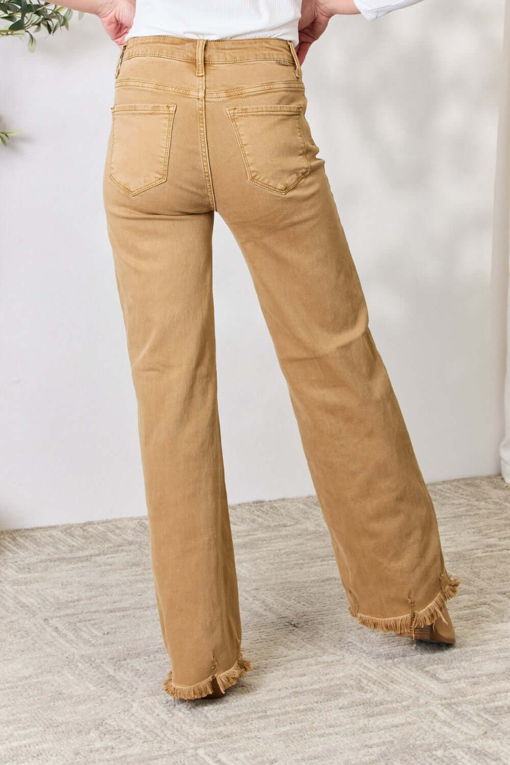 Risen Jeans Wide Leg Fringe Hem Jeans in tan, showcasing rear view with pocket details and slightly frayed edges.