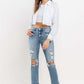 Woman wearing Lovervet Full Size High Rise Slim Straight Jeans with a white cropped top and white sneakers.