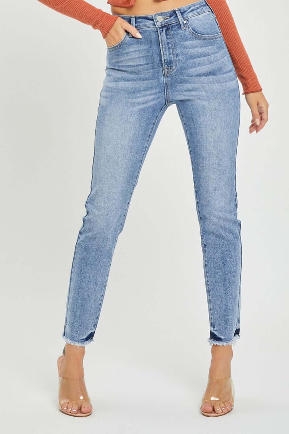 High rise frayed hem skinny jeans by Risen Jeans on model showing trendy and versatile fit