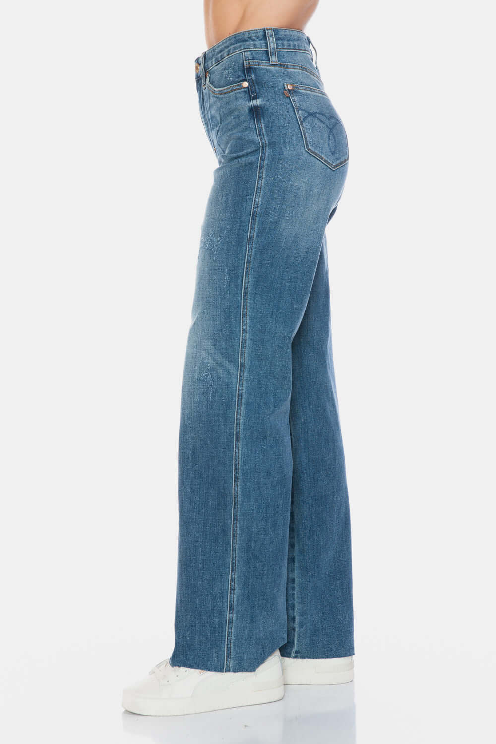 Judy Blue high-waist tummy control jeans with raw hem in side view, showcasing trendy style and comfortable fit.