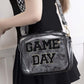 Transparent crossbody bag with "GAME DAY" text, featuring glittered trim and a stylish strap for stadium events.