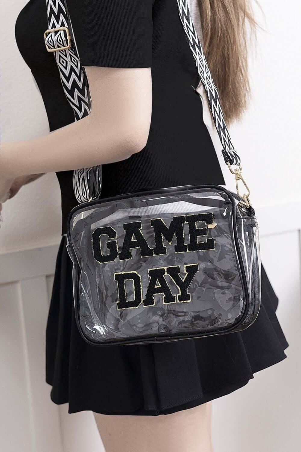 Transparent crossbody bag with "GAME DAY" text, featuring glittered trim and a stylish strap for stadium events.