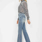 Model showcasing full size tummy control bootcut jeans with embroidered pockets and stylish top.