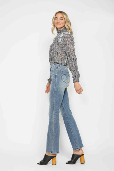 Model showcasing full size tummy control bootcut jeans with embroidered pockets and stylish top.