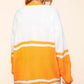 Woman wearing a loose-fitting, long-sleeve white and yellow striped cardigan, showcasing the back view.