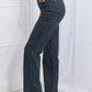 Woman wearing Cassidy full size high waisted tummy control striped straight Judy Blue jeans, side view showing fit and design.