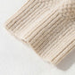 Close-up of Bella Road tan cable-knit sweater sleeve, showcasing cozy texture and stylish design. Perfect for cool days and fashion-forward looks.