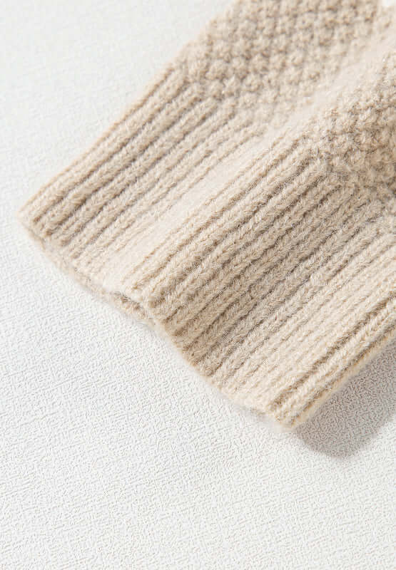 Close-up of Bella Road tan cable-knit sweater sleeve, showcasing cozy texture and stylish design. Perfect for cool days and fashion-forward looks.