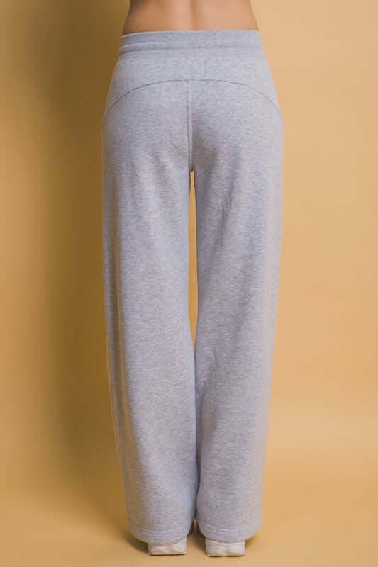 Back view of gray drawstring wide leg sweatpants with pockets, perfect for comfy loungewear and casual outfits.